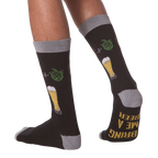 Lifestyle shot of a person wearing the 'Bring Me A Beer' socks, demonstrating fit and style.