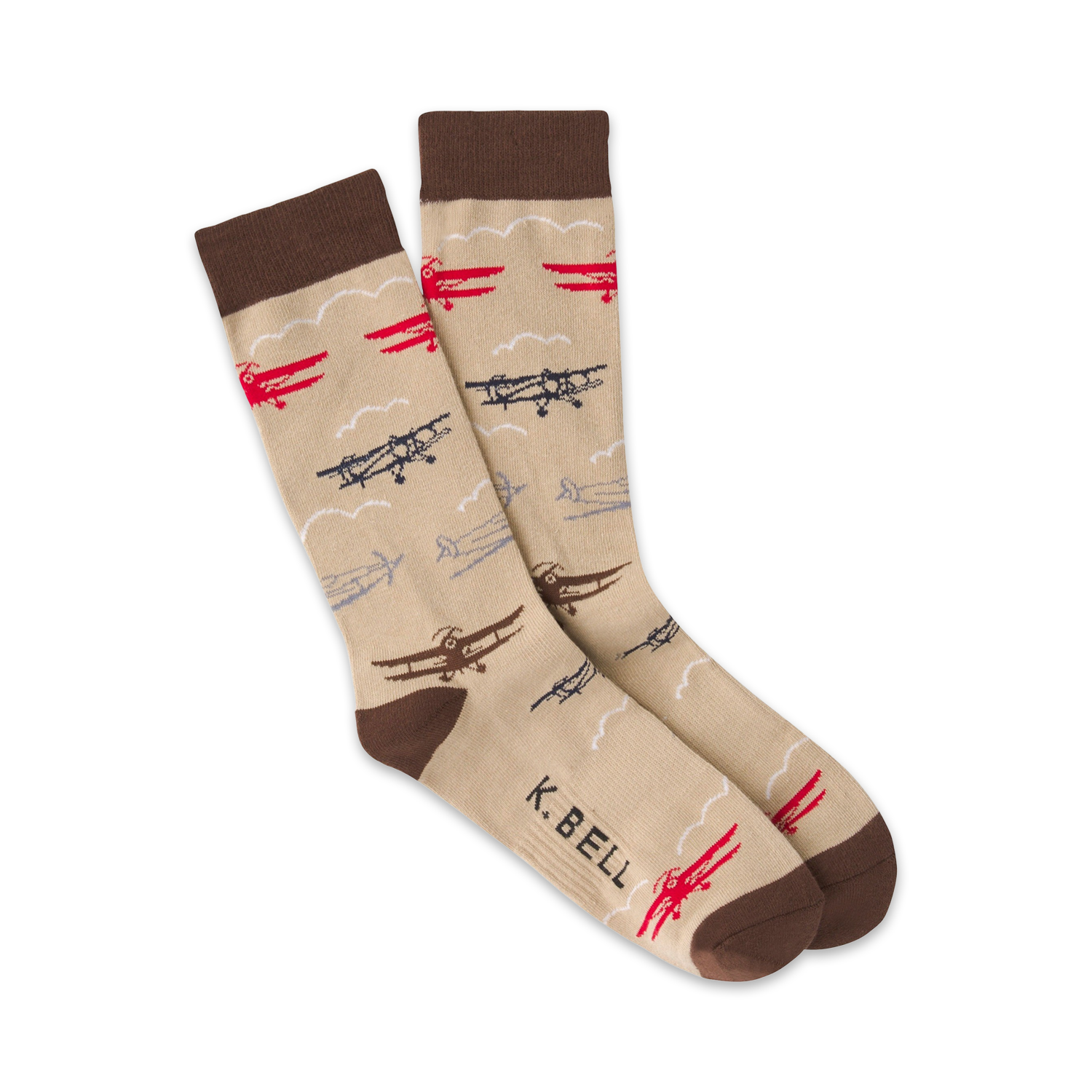 Pair of beige crew socks with a pattern of red, brown, and navy biplanes and clouds. Brown cuff. 'K.Bell' subtly printed on the sock.