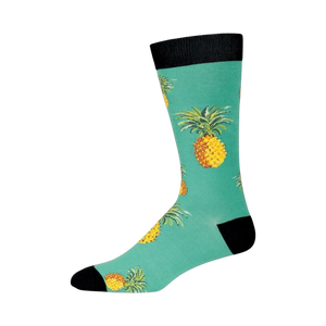 Side view of a single teal crew sock with pineapples. Shows the full length and design details.