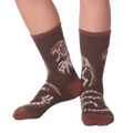 Lifestyle shot of Dino Bones socks on a person's feet.