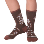 Lifestyle shot of Dino Bones socks on a person's feet.