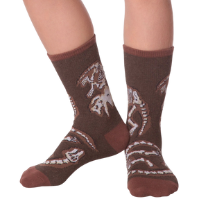 Lifestyle shot of Dino Bones socks on a person's feet.