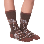 Another lifestyle shot of Dino Bones socks on a person's feet.