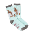 Pair of pastel blue crew socks featuring horses in a fence and a small dog. Gray cuffs and 'Hold Your Horses' text on the sole.
