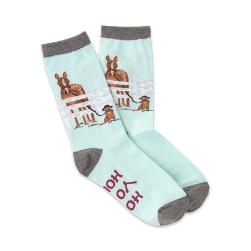 Pair of pastel blue crew socks featuring horses in a fence and a small dog. Gray cuffs and 'Hold Your Horses' text on the sole.