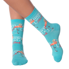 Lifestyle shot of model wearing 'I Don't Give a Flock' flamingo socks.