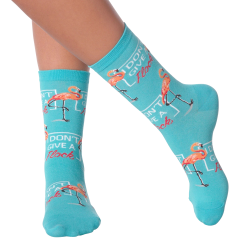 Lifestyle shot of model wearing 'I Don't Give a Flock' flamingo socks.
