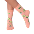 Lifestyle shot of woman's legs wearing peach avocado socks.