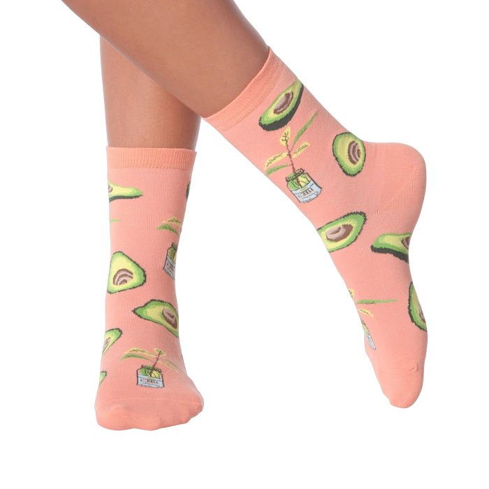 Lifestyle shot of woman's legs wearing peach avocado socks.
