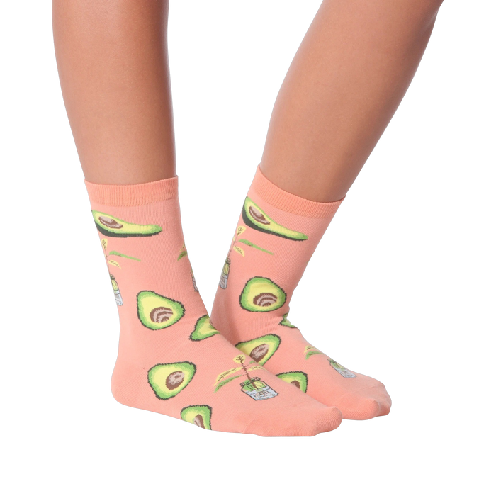 Lifestyle shot of woman's legs wearing peach avocado socks, different pose.