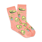 Pair of peach-colored crew socks with illustrated avocados and small potted avocado plants. 