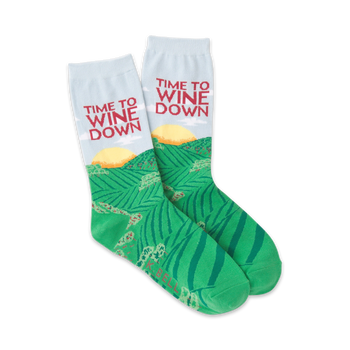 green crew socks with white cuff and text "time to wine down" featuring a pattern of rolling green hills and setting sun.  