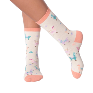 Lifestyle shot showing a person's legs wearing the pastel llama socks.