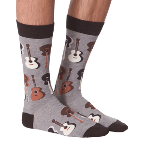 A pair of gray socks with a pattern of brown acoustic guitars.
