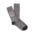 Pair of grey crew socks with a graphic of a cowbell and mallets. Text reads 'More Cowbell'. Dark grey cuffs.