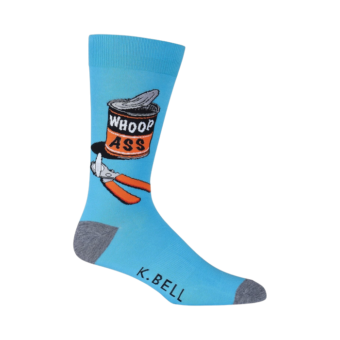 Close-up of a single blue 'Whoop Ass' sock on a black background, showing detail of the design.