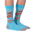 Flat lay photo of a pair of 'Whoop Ass' socks on a black background.