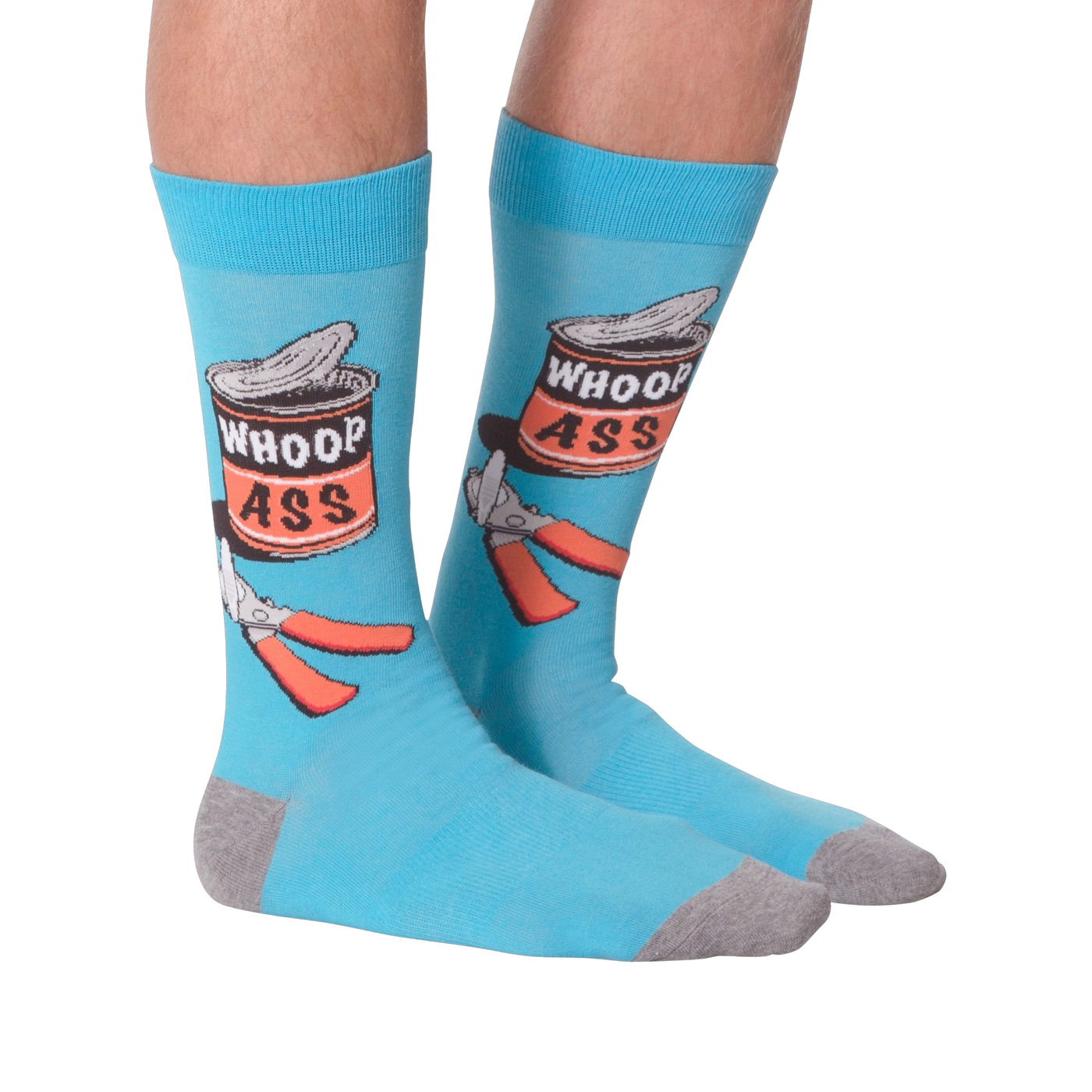 Flat lay photo of a pair of 'Whoop Ass' socks on a black background.