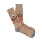 Tan crew socks with a whimsical brown poop emoji design. The emoji says 'Hey!' and the socks read 'Shit Happens'.
