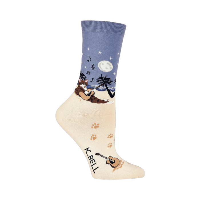 Crew socks showing a cat playing guitar on a beach at night.  The main colors are cream, blue, and brown. }}