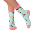 Lifestyle shot of a person wearing the Musical Dogs socks, showcasing how they look on the feet.