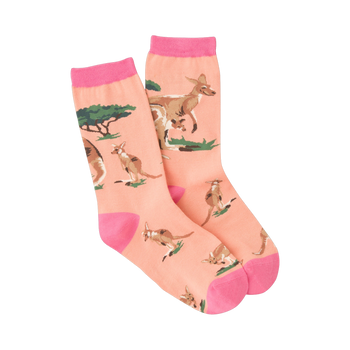 A pair of peach crew socks with pink cuffs, featuring a repeating pattern of kangaroos and small green bushes.