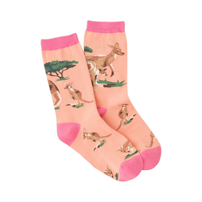 A pair of peach crew socks with pink cuffs, featuring a repeating pattern of kangaroos and small green bushes.