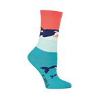 Crew socks in coral, teal, and white featuring an orca whale design against a sunset backdrop. Orcas are also shown swimming near the bottom of the sock.