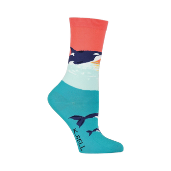 Crew socks in coral, teal, and white featuring an orca whale design against a sunset backdrop. Orcas are also shown swimming near the bottom of the sock.