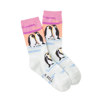Crew socks in pastel pink, peach, and mint green featuring an illustration of Emperor penguins on ice floes.