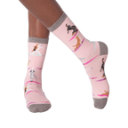 Lifestyle shot of woman's legs wearing Yoga Dogs socks and black sneakers.