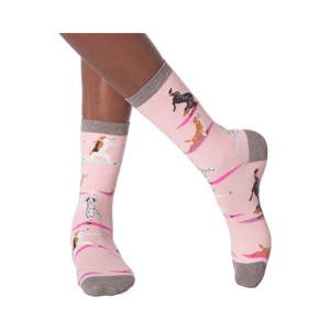 Lifestyle shot of woman's legs wearing Yoga Dogs socks and black sneakers.