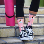 Side view of a single Yoga Dogs sock on a black background, showcasing the sock's design and fit. [lf]