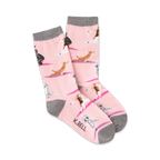 Pair of pink crew socks featuring yoga dogs in various poses. Gray cuff detail.