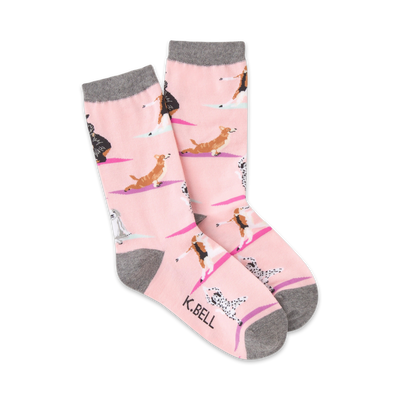 pink crew socks with gray toes, heels, and cuffs imprinted with a repeating pattern of cartoon dogs in various yoga poses. available in ladies sizes.   