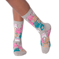Close-up of a person's legs wearing grey Smarty Cats socks.