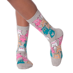 Close-up of a person's legs wearing grey Smarty Cats socks.
