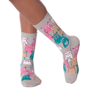 Close-up of a person's legs wearing grey Smarty Cats socks.