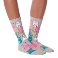 Lifestyle shot showing a model wearing white Smarty Cats socks.