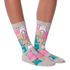 Lifestyle shot showing a model wearing white Smarty Cats socks.