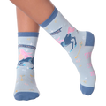 Lifestyle shot of woman's legs wearing a pair of Sagittarius socks.
