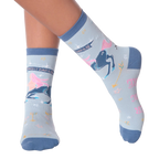 Lifestyle shot of woman's legs wearing a pair of Sagittarius socks.