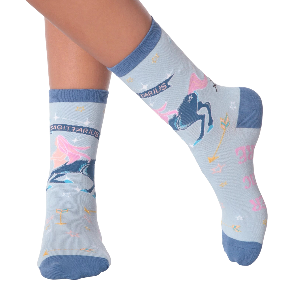 Lifestyle shot of woman's legs wearing a pair of Sagittarius socks.
