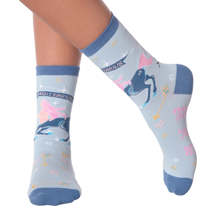 Lifestyle shot of woman's legs wearing a pair of Sagittarius socks.