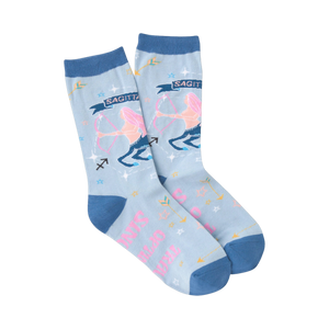 Pair of light blue crew socks with a Sagittarius zodiac design. Features pink Sagittarius figure, arrows, and stars.