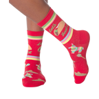Lifestyle shot: Woman's legs wearing the 'Let's Taco Bout It' socks while casually holding a taco.