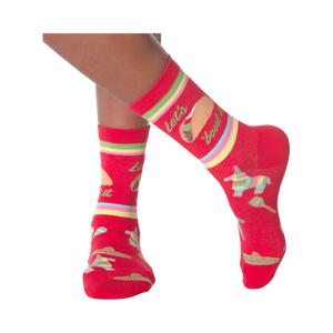 Lifestyle shot: Woman's legs wearing the 'Let's Taco Bout It' socks while casually holding a taco.