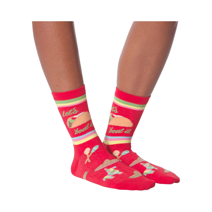 Pair of 'Let's Taco Bout It' socks on a black background, showcasing the full design.