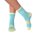 Close-up of a model's legs wearing the Beer Lime Sunshine socks.  Shows the socks on feet.