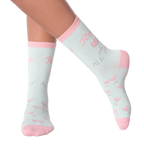 Lifestyle shot of woman's legs wearing 'Rose All Day' socks.